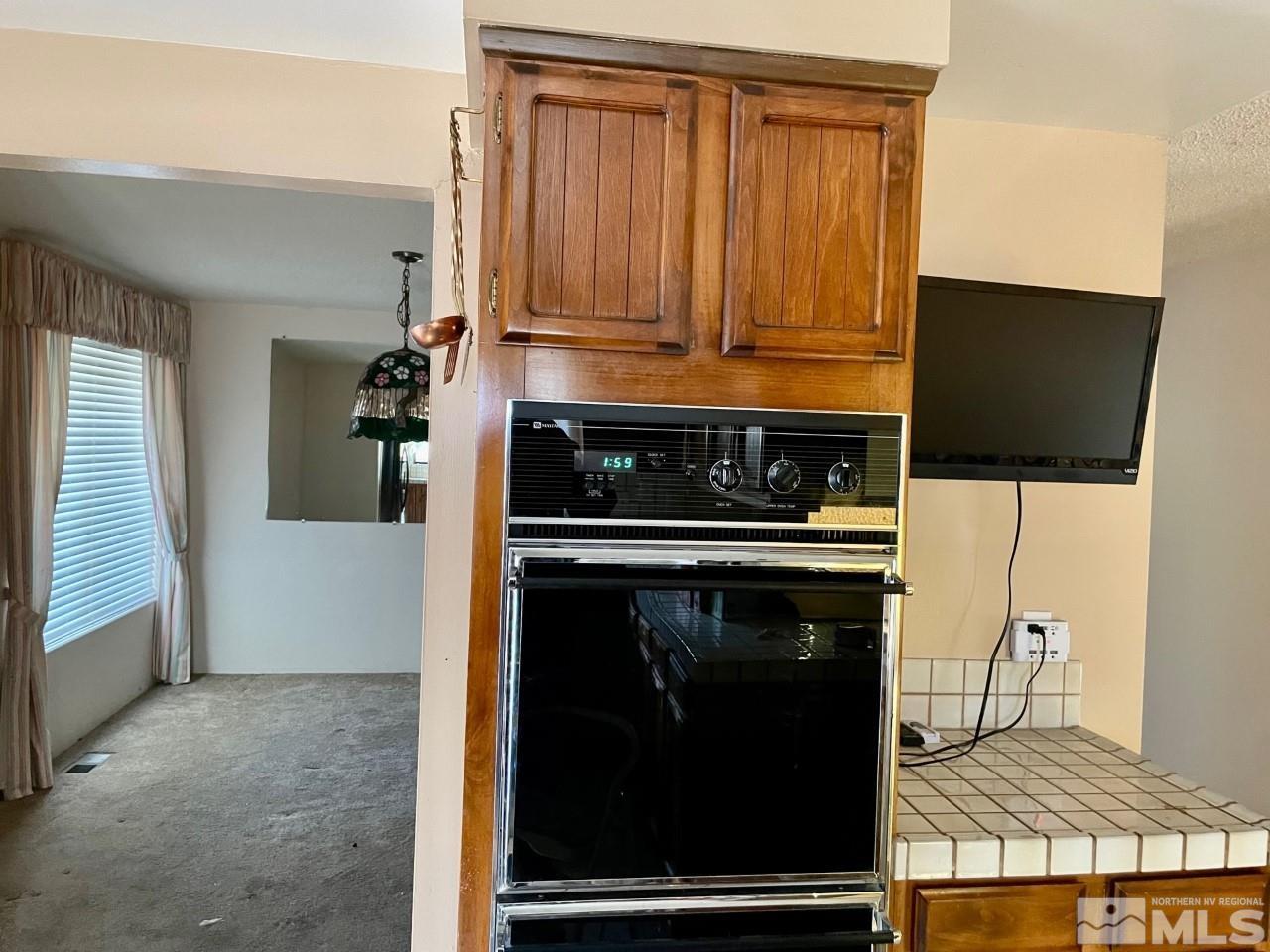 3280 Idlewild Drive Reno, NV 89509 - Photo 8 of 22 a stove top oven sitting inside of a kitchen