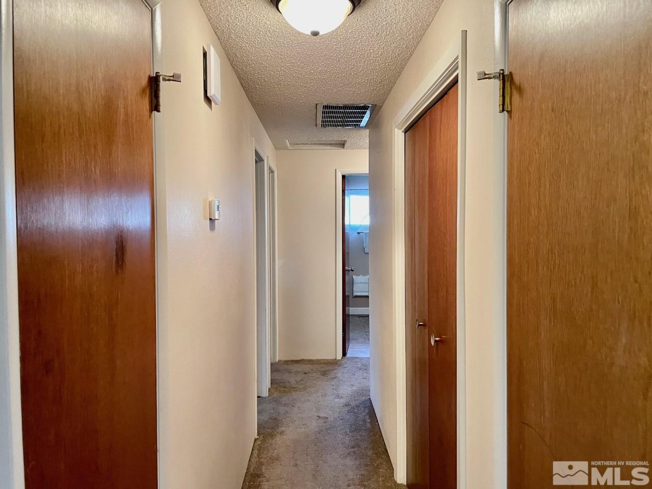3280 Idlewild Drive Reno, NV 89509 - Photo 10 of 22 a view of a hallway with wooden floor