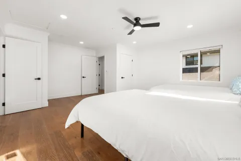 a spacious bathroom with a double vanity sink a mirror and shower