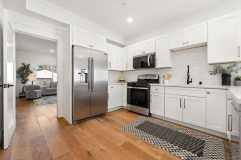 a kitchen with a refrigerator stove and microwave