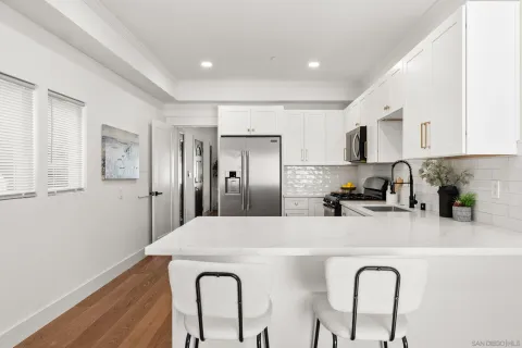 a living room with furniture and kitchen view