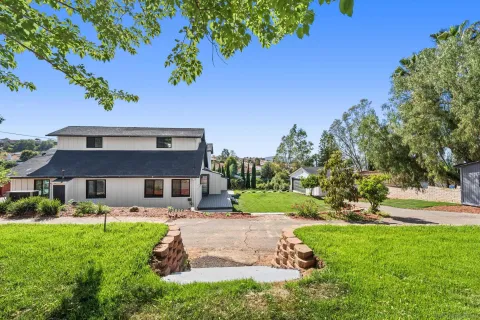 a view of backyard with outdoor seating and green space