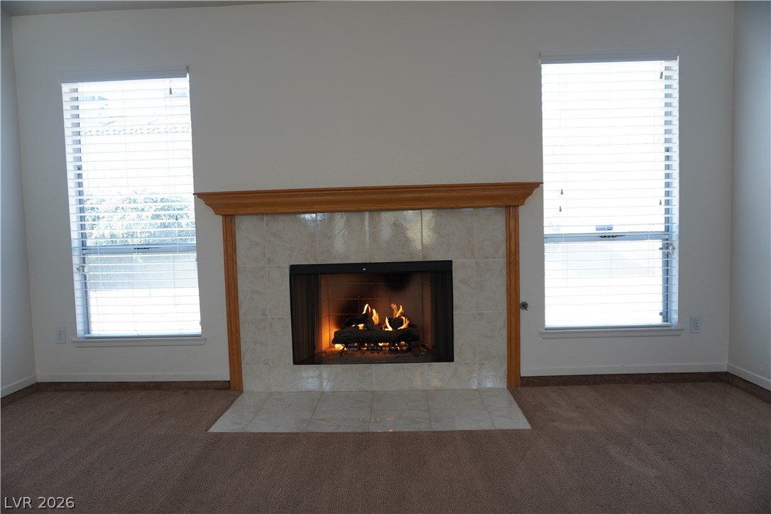8328 Del Rey Avenue Las Vegas, NV 89117 - Photo 21 of 38 Warm up by the charming tile fireplace, flanked by dual windows for balanced light.