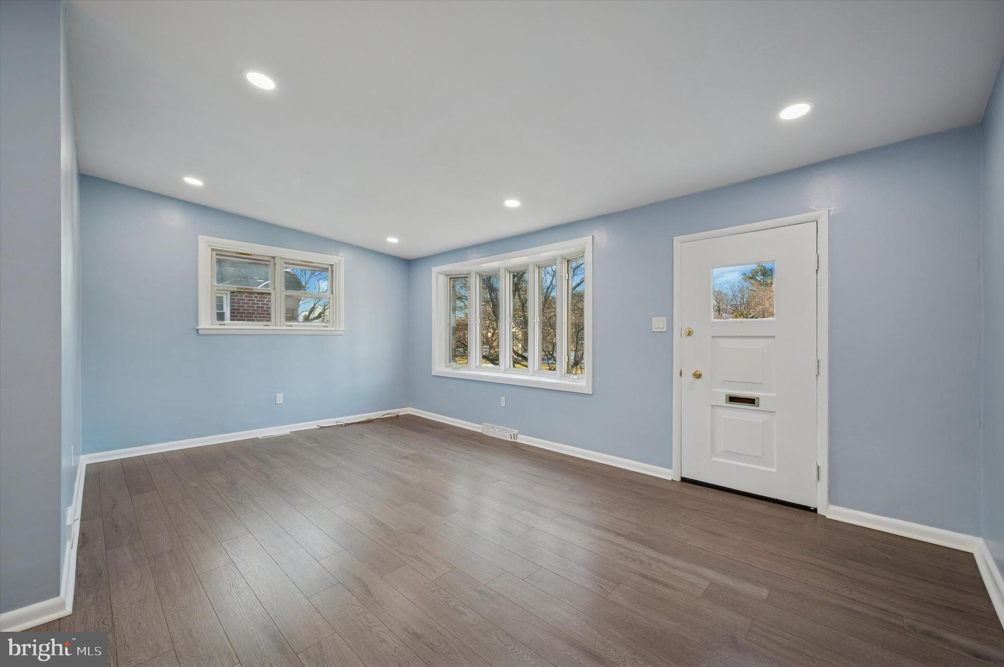 555 Wanamaker Road Jenkintown, PA 19046 - Photo 4 of 26 an empty room with wooden floor and windows