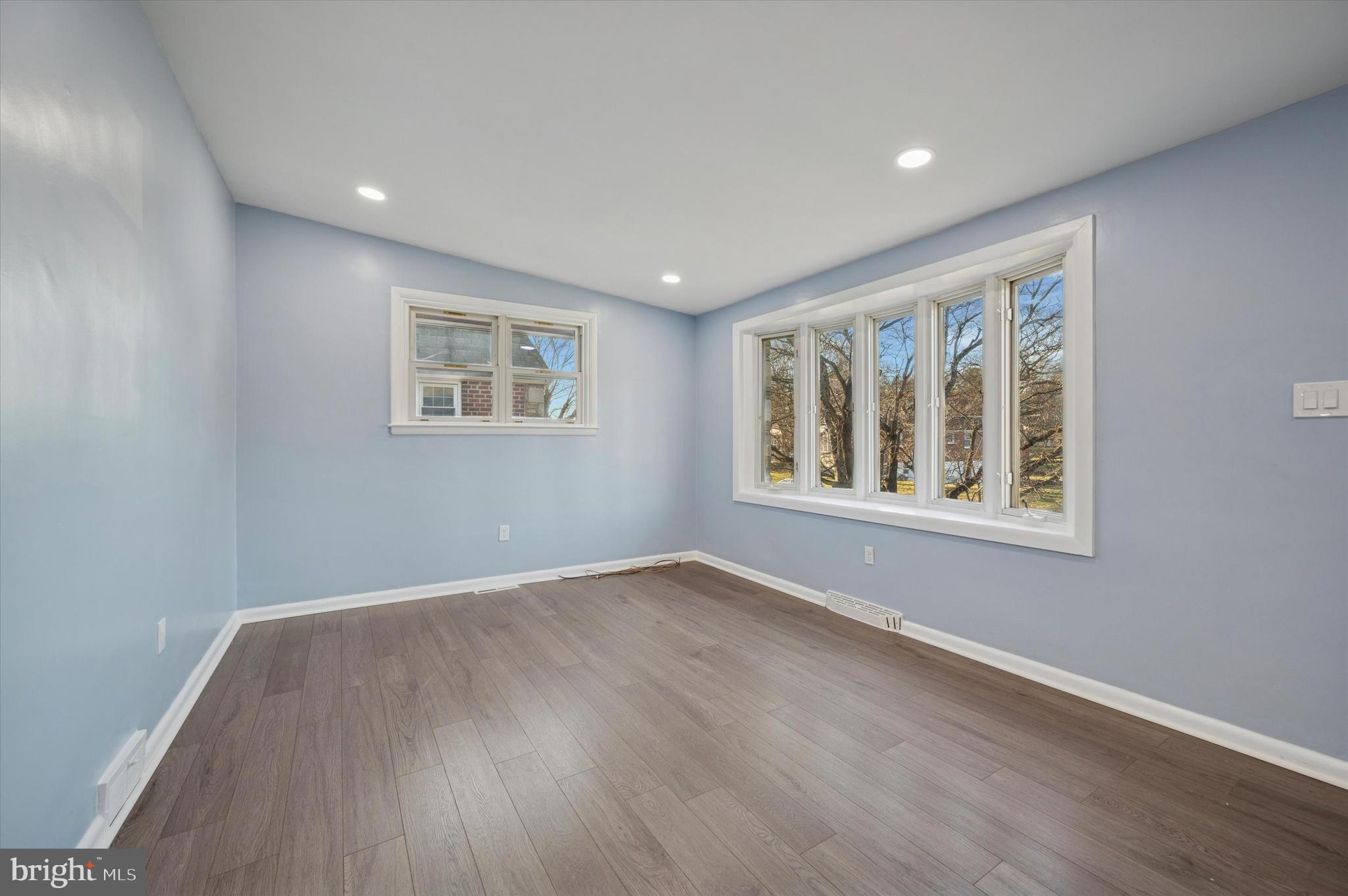 555 Wanamaker Road Jenkintown, PA 19046 - Photo 5 of 26 a view of an empty room with wooden floor and a window