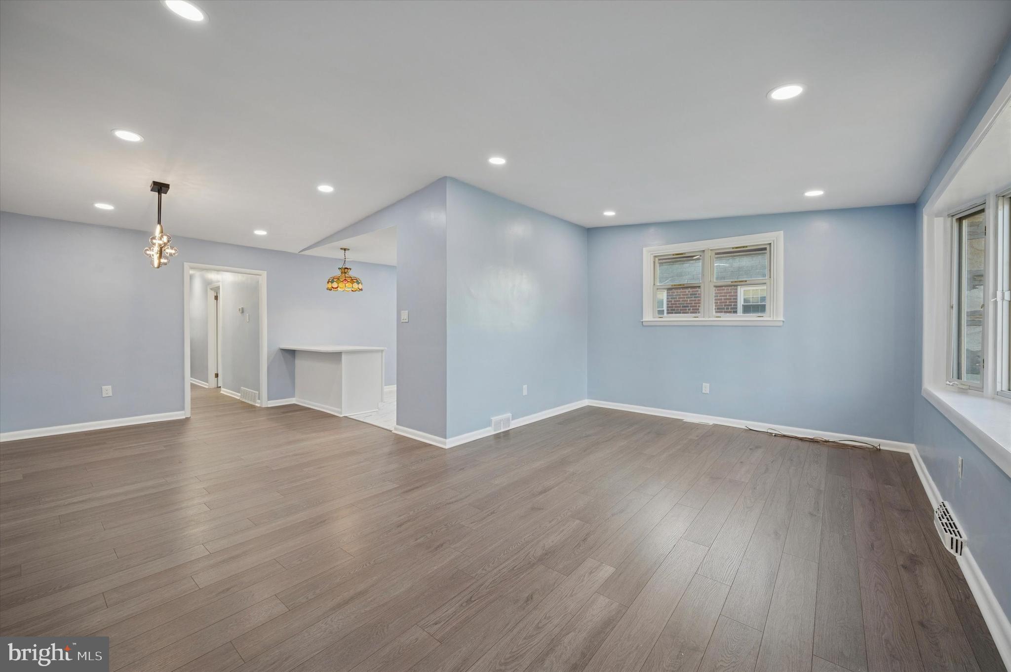 555 Wanamaker Road Jenkintown, PA 19046 - Photo 6 of 26 an empty room with wooden floor and windows