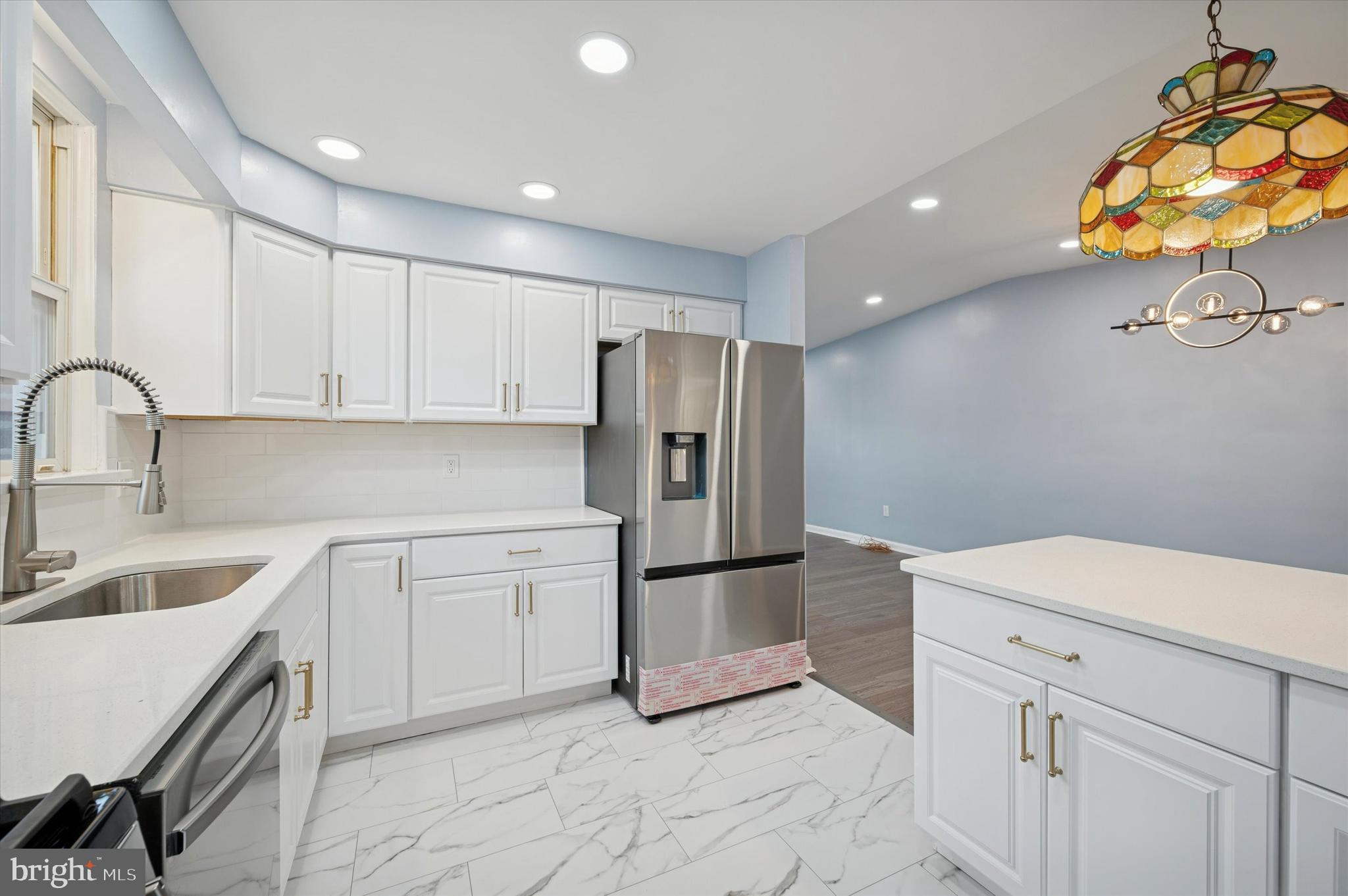 555 Wanamaker Road Jenkintown, PA 19046 - Photo 7 of 26 a kitchen with a sink cabinets and stainless steel appliances