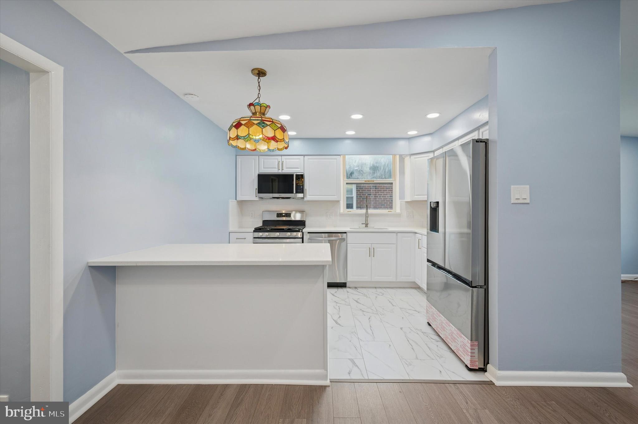 555 Wanamaker Road Jenkintown, PA 19046 - Photo 8 of 26 a kitchen with stainless steel appliances a microwave a stove a sink cabinets and a counter top space
