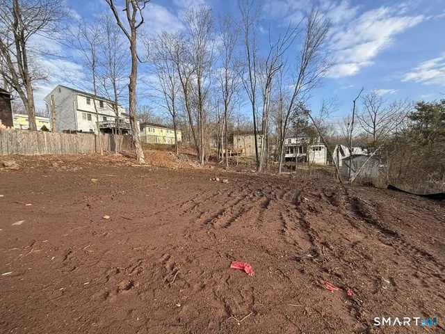 a backyard of a house with large trees