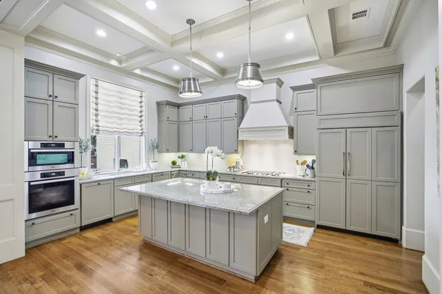 a kitchen with a sink window and stainless steel appliances