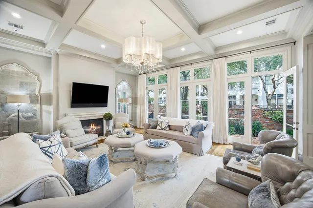a living room with patio furniture and a flat screen tv