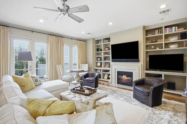 a living room with furniture a fireplace and a flat screen tv