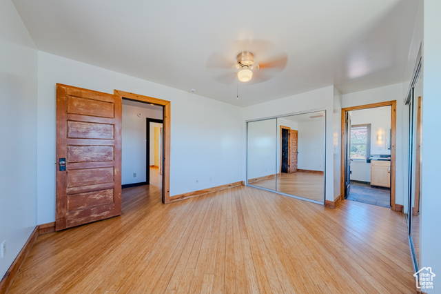 6178 East Zion Road Kanab, UT 84741 - Photo 24 of 48 Unfurnished bedroom featuring wood finished floors, a closet, and ceiling fan