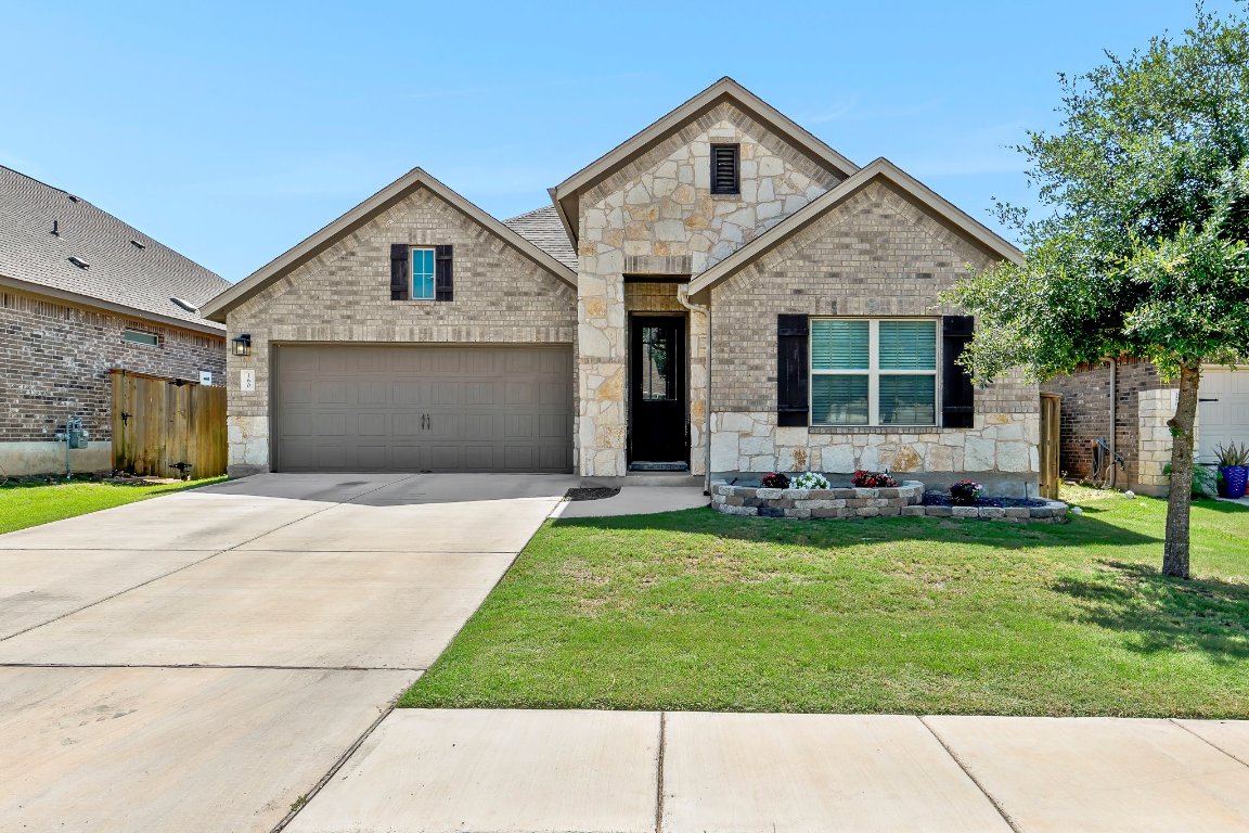 a front view of a house with a garden and plants