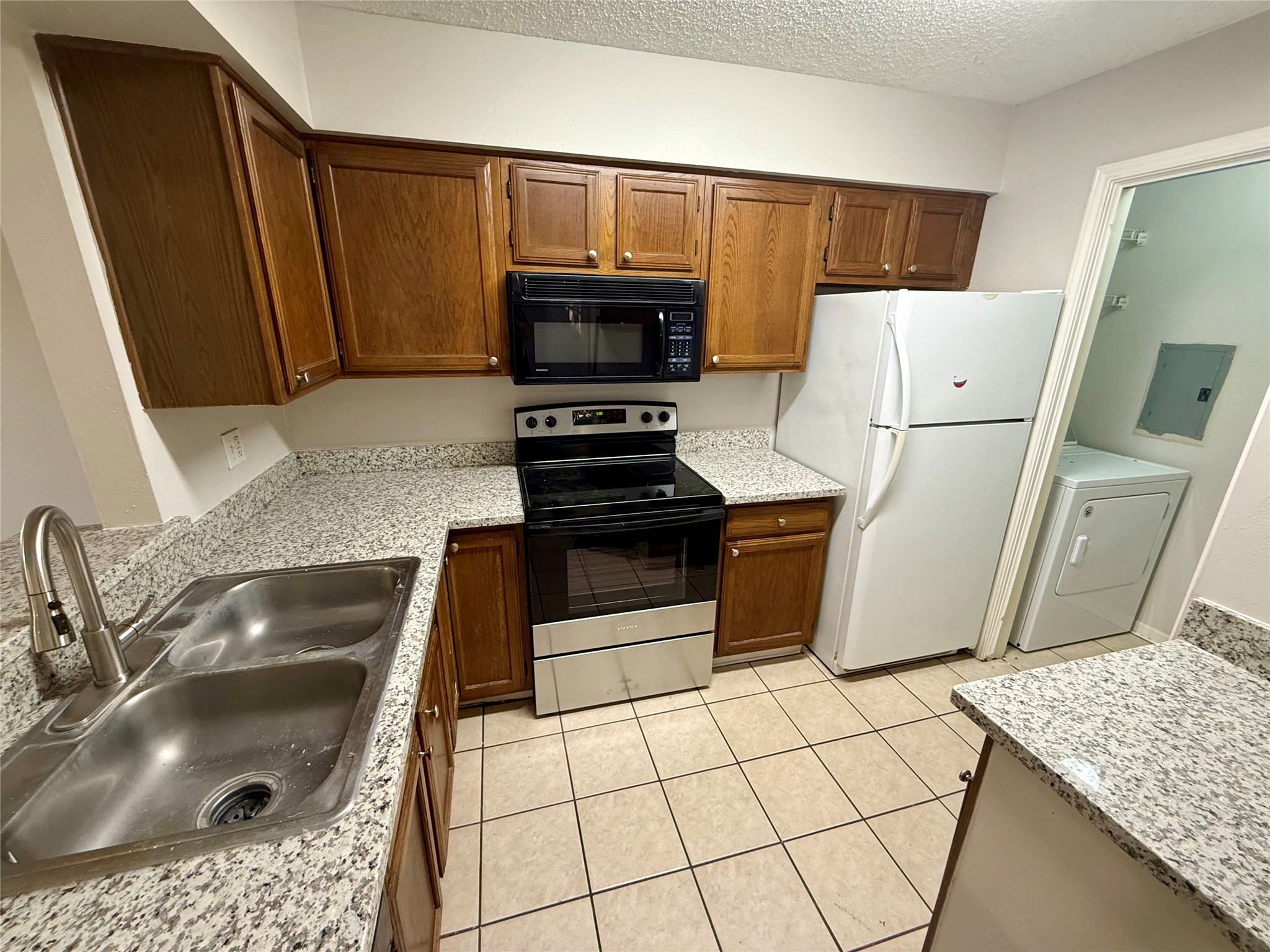 25144 Budde Road, Unit 7 Spring, TX 77380 - Photo 1 of 7 a kitchen with a sink a stove and a refrigerator