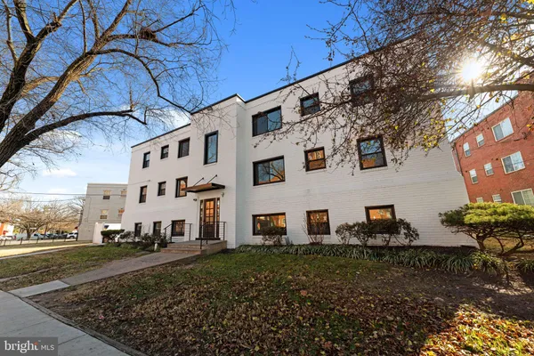 a view of a white house with a yard