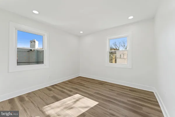 a room with a bed and a painting on the wall