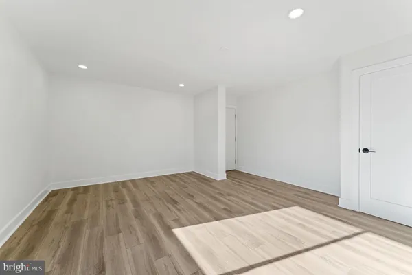 a view of a room with wooden floor and white walls