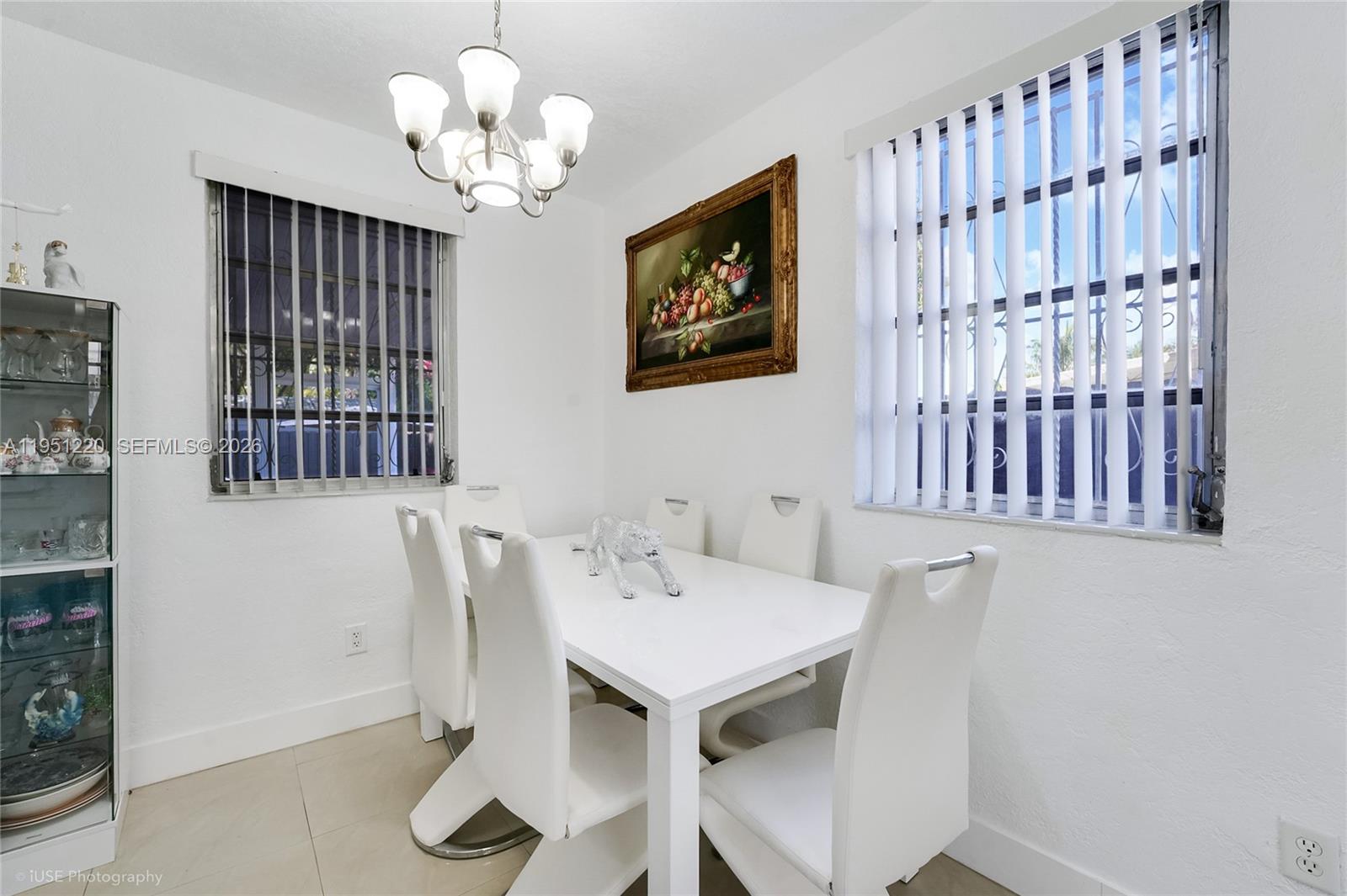 860 Southeast 7th Avenue Hialeah, FL 33010 - Photo 6 of 16 a view of a dining room with furniture and chandelier