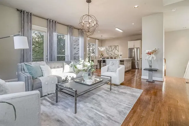 a living room with furniture and a chandelier