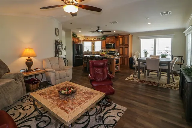 a living room with lots of furniture and kitchen view