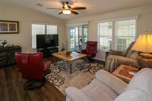 a living room with furniture a large window and a flat screen tv