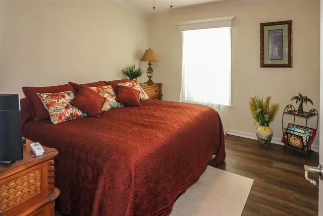 a large bed sitting in a bedroom next to a window