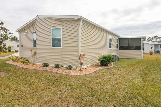 a view of a house with a yard and sitting area