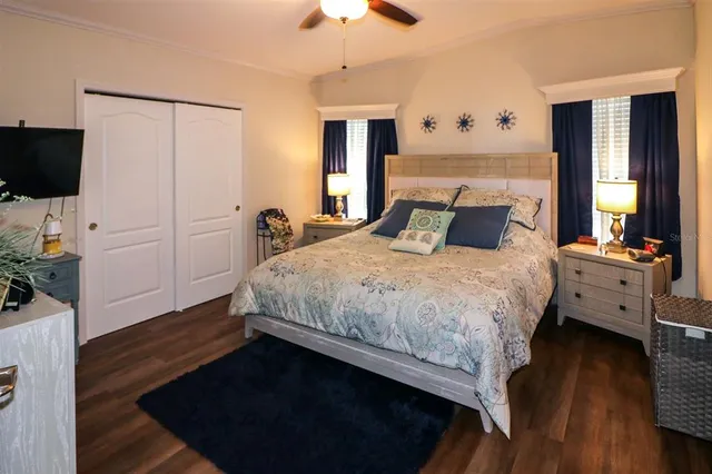 a bedroom with a bed and a chandelier