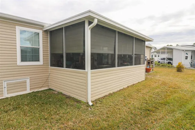 a view of a house with a backyard