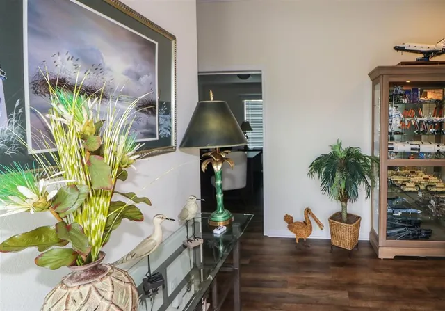 a vase of flowers sitting on a table with chairs