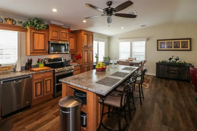 a kitchen with a stove a sink a dining table and chairs
