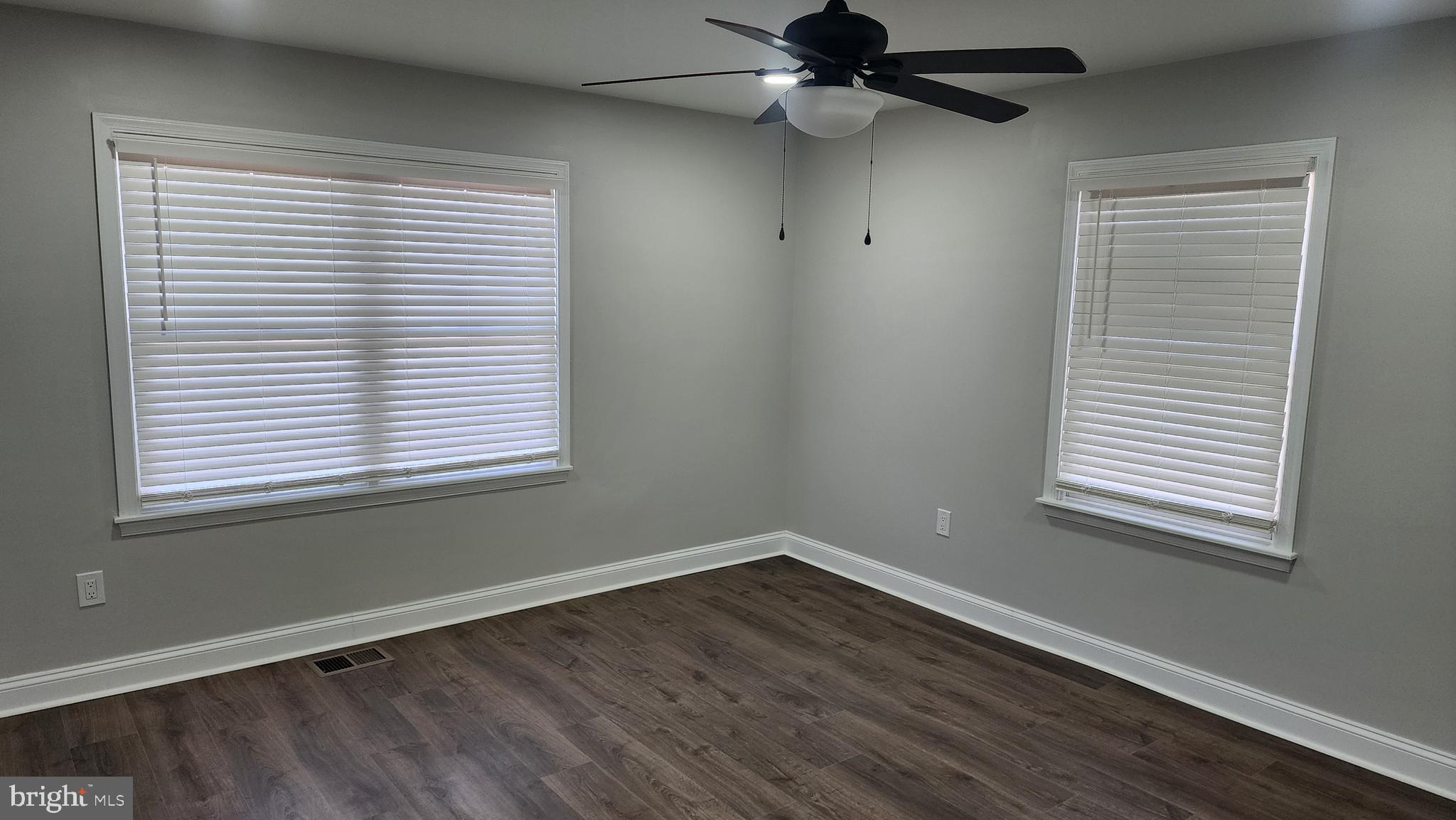 706 East Division Street Dover, DE 19901 - Photo 13 of 20 a view of an empty room with wooden floor and a window