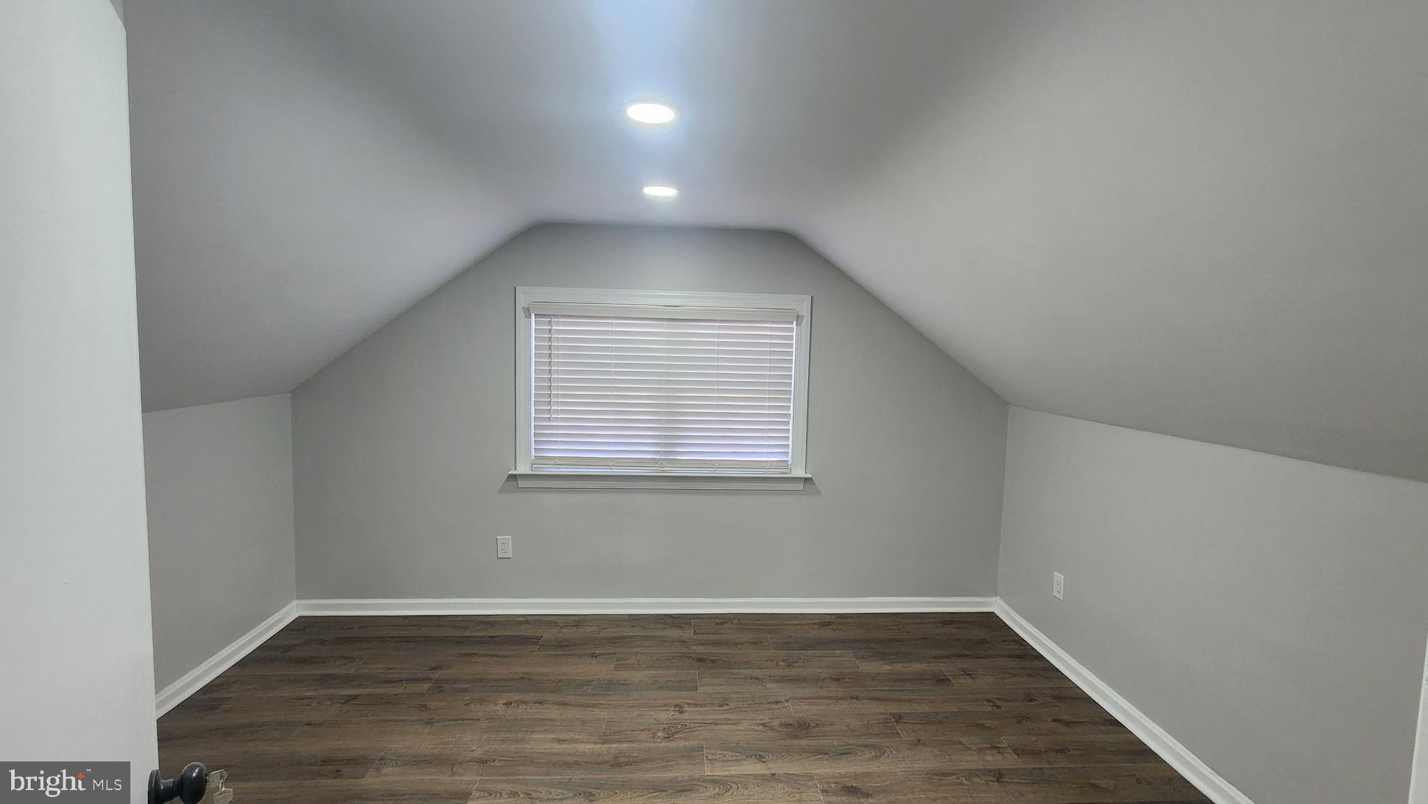 706 East Division Street Dover, DE 19901 - Photo 16 of 20 an empty room with wooden floor and windows