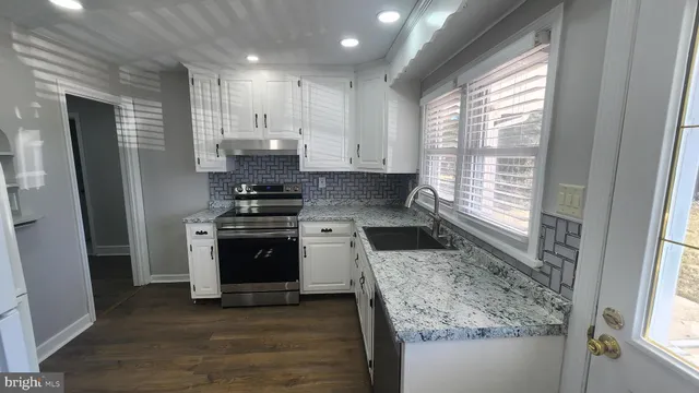 a kitchen with a stove a sink and a refrigerator
