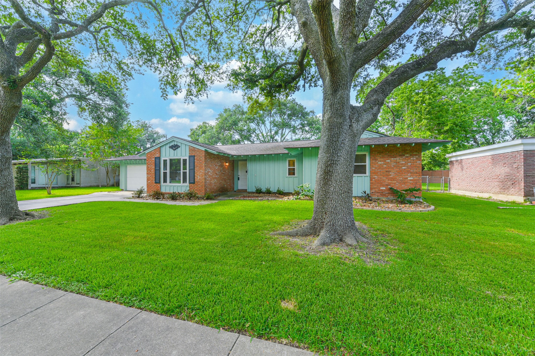 a front view of house with a garden and patio