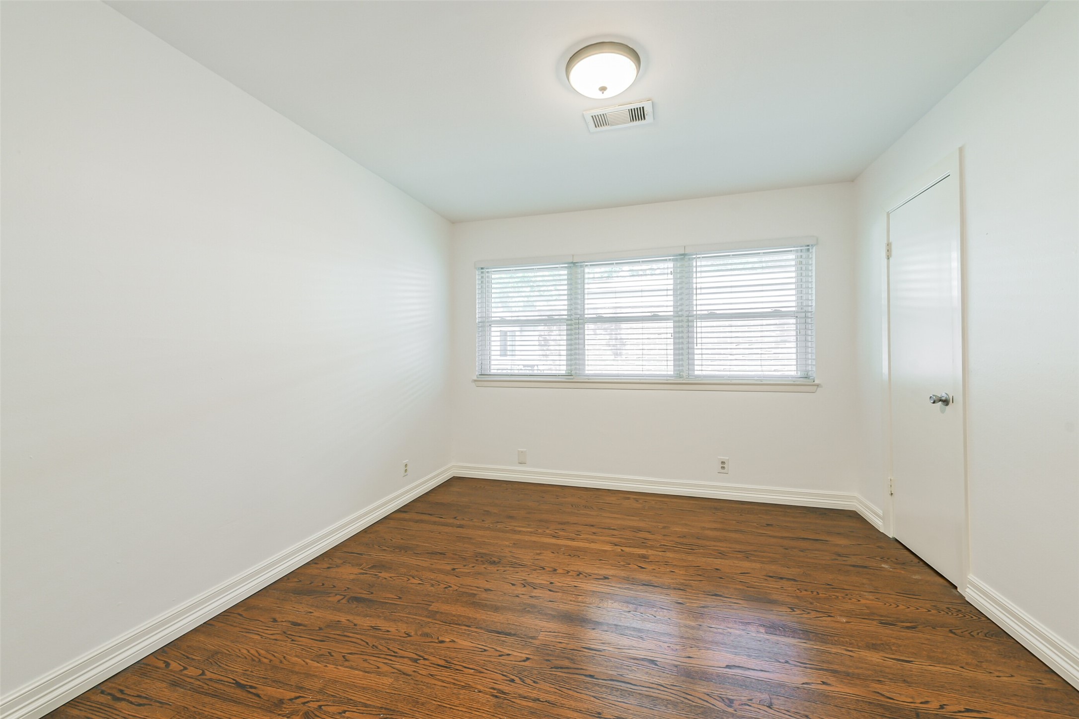 10251 Old Orchard Road La Porte, TX 77571 - Photo 11 of 15 an empty room with wooden floor and windows
