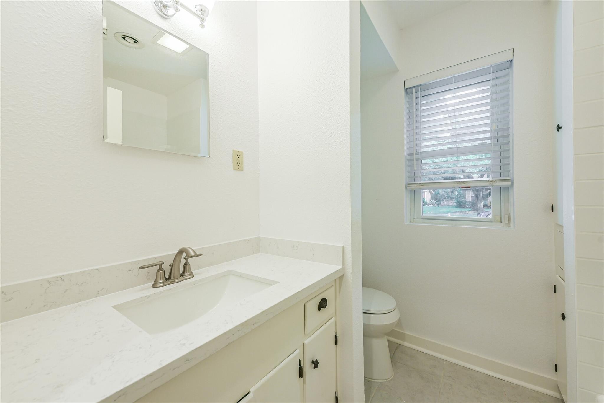 10251 Old Orchard Road La Porte, TX 77571 - Photo 13 of 15 a bathroom with a sink toilet and a mirror