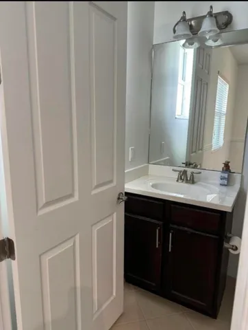 a bathroom with a sink vanity and a mirror