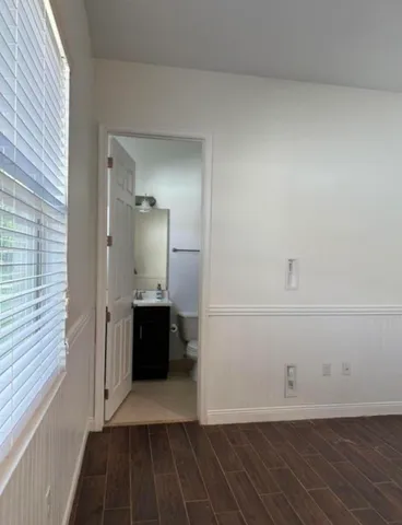 a view of a closet area with wooden floor