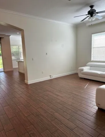 wooden floor in an empty room with a window