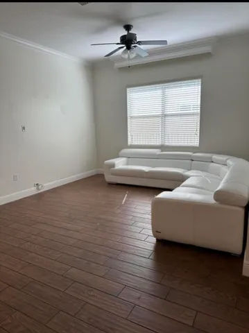 a living room with couches and chandelier