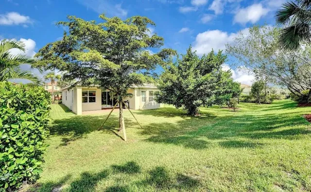 a view of a house with a backyard