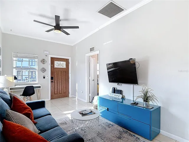a living room with furniture and a wooden floor