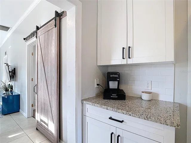 a kitchen with stainless steel appliances granite countertop a refrigerator and a stove