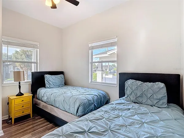 a bedroom with two beds and window
