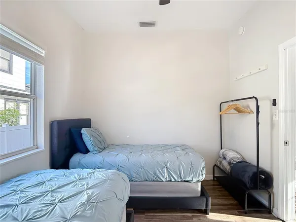 a bedroom with a bed and a window