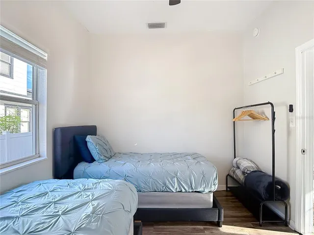 a bedroom with a bed and a window