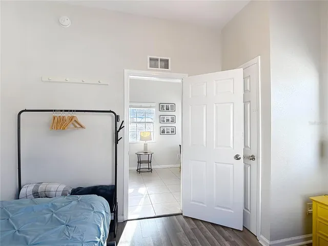 a bedroom with a bed and a window