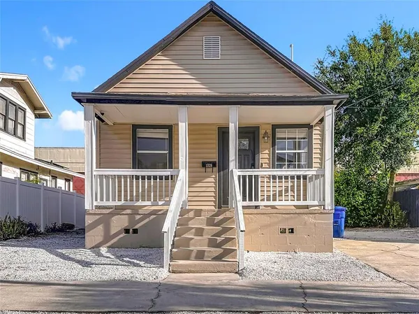 a front view of a house with wooden stairs